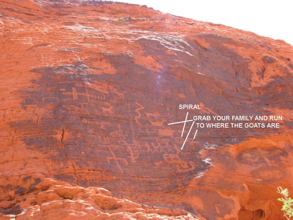 Spirals, goats, people escaping holding hands in this petroglyph