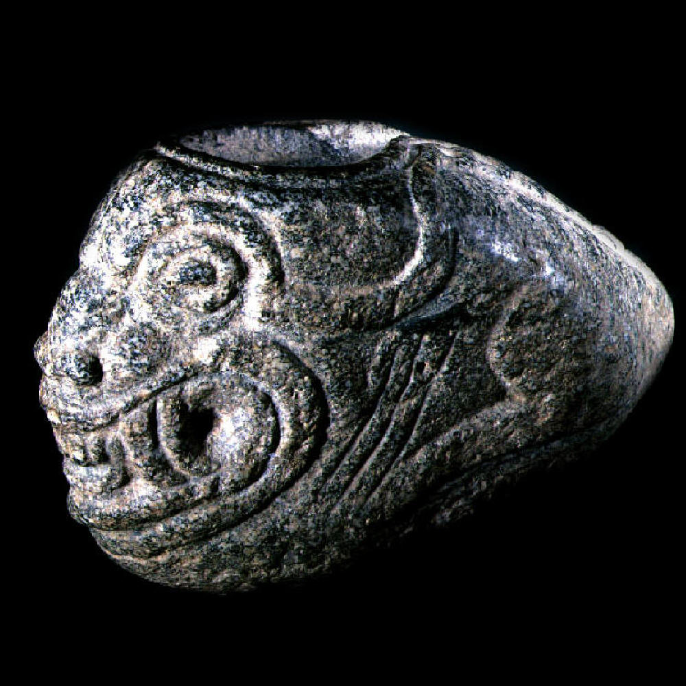 Olmec serpent head carved in stone.